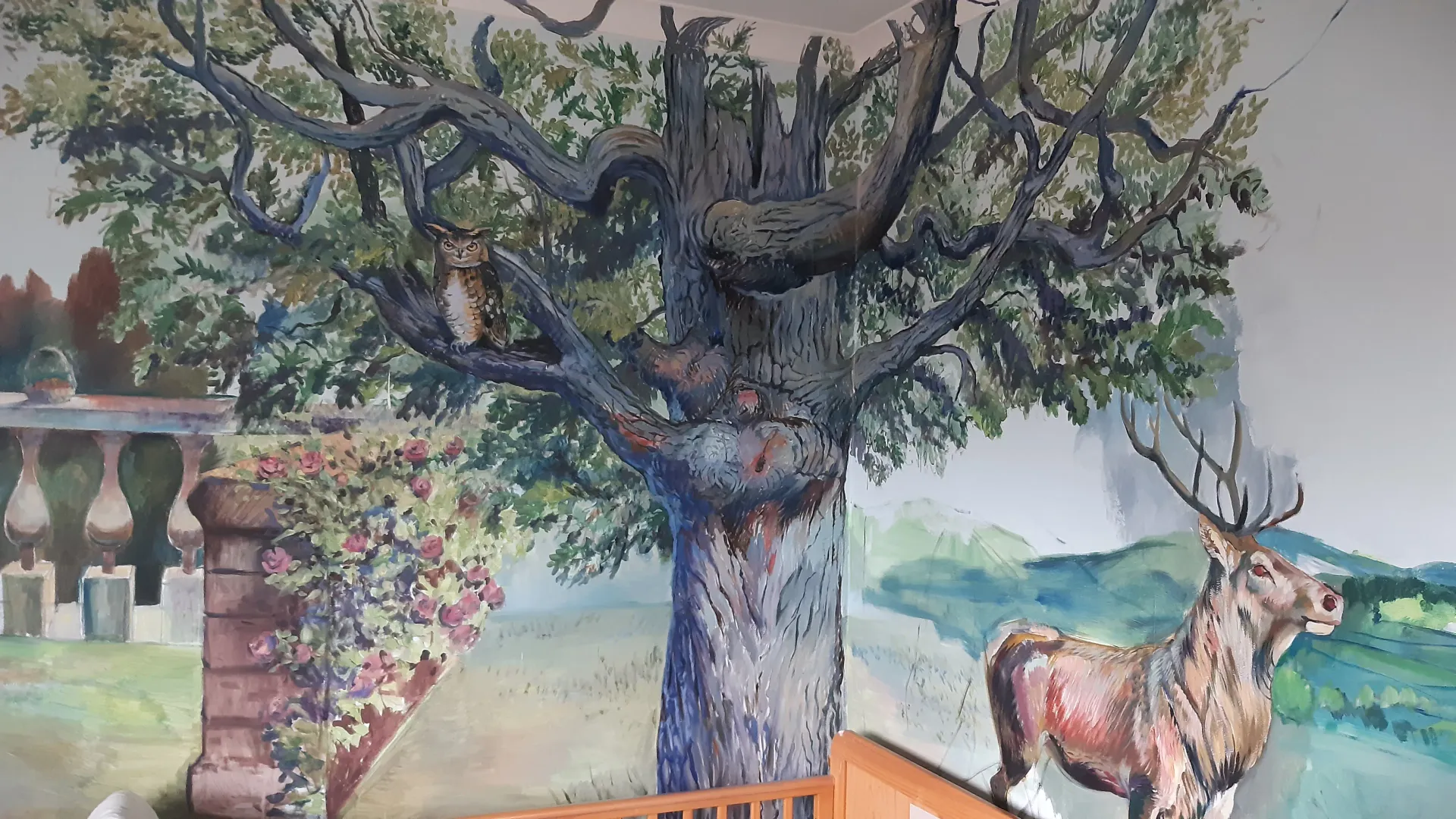 Hand-painted woodland mural with an owl and deer
